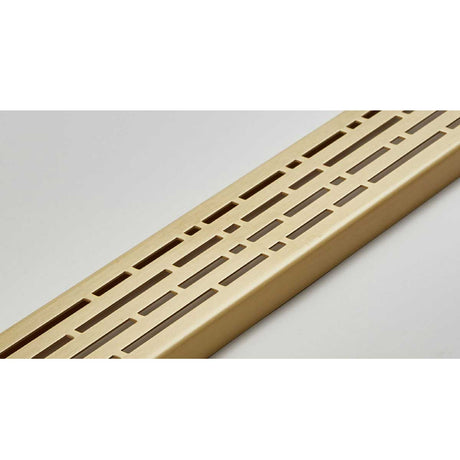 Quartz by ACO Satin Brass linear shower drain installed in contemporary curbless shower