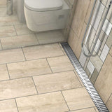 Quartz by ACO polished chrome Piano grate linear shower drain installed in a modern tile shower floor