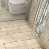 Satin Brass Quadrato linear shower drain with geometric square grate
