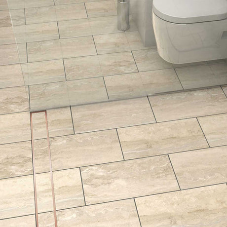 Stainless steel linear shower drain with tile insert grate and Rose Gold trim