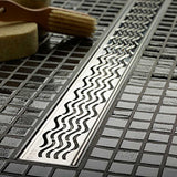 Quartz Plus linear shower drain with Waves stainless steel grate