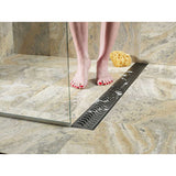 QuARTz Linear Shower Drain with Flag Grate - Oil Rubbed Bronze Installed in shower floor and women feet taking shower