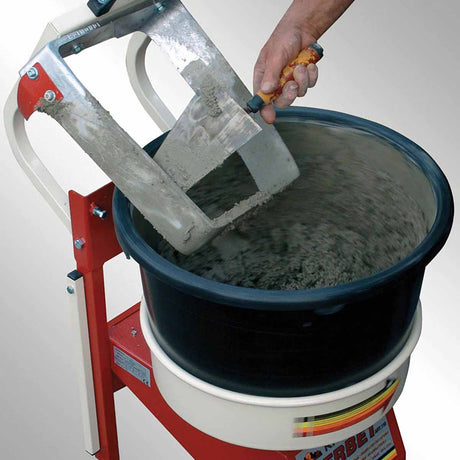 Professional tile installer operating Raimondi rotating bucket mixer during commercial renovation project