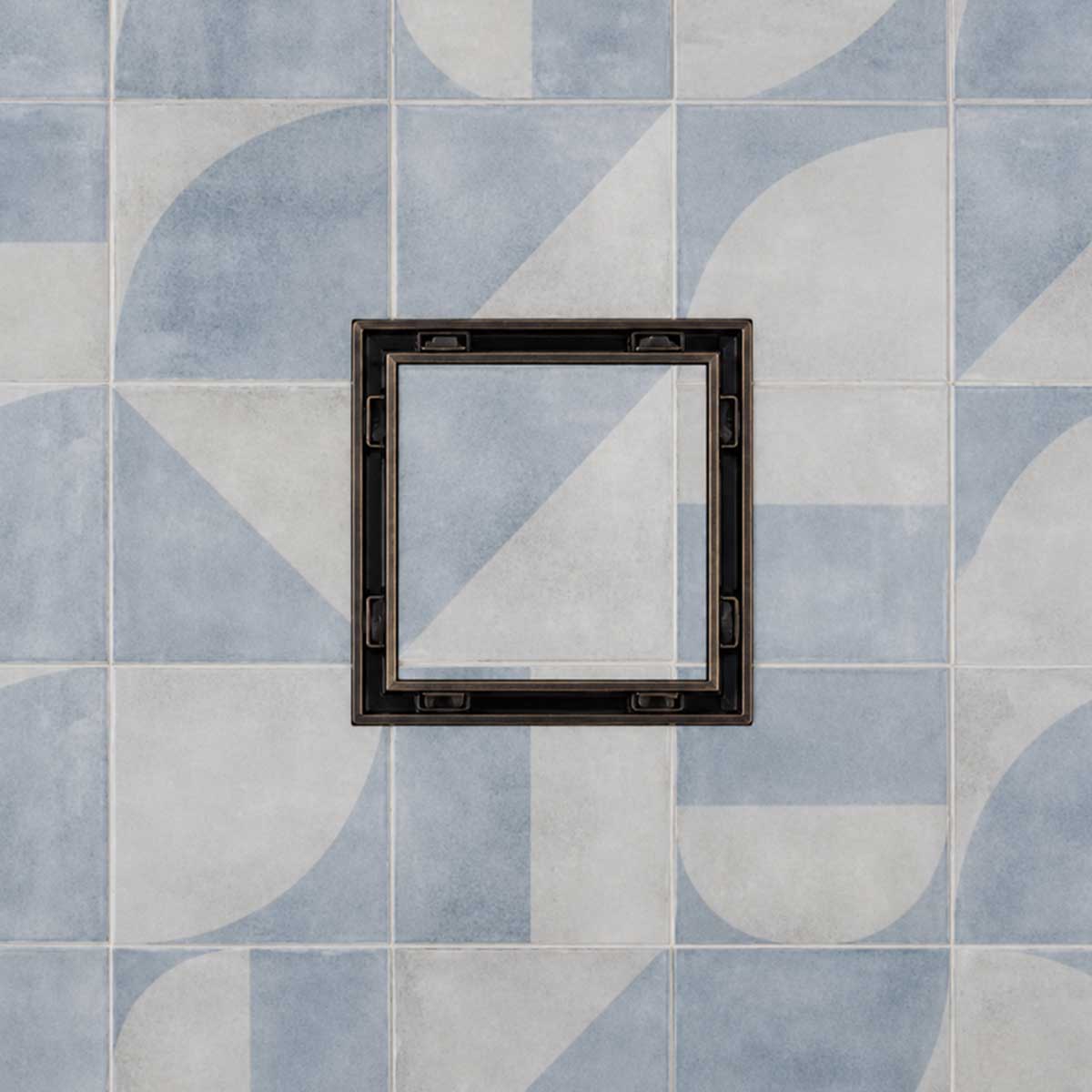 Serene Drains 5 inch square tile insert drain with ORB frame on blue and white patterned tile