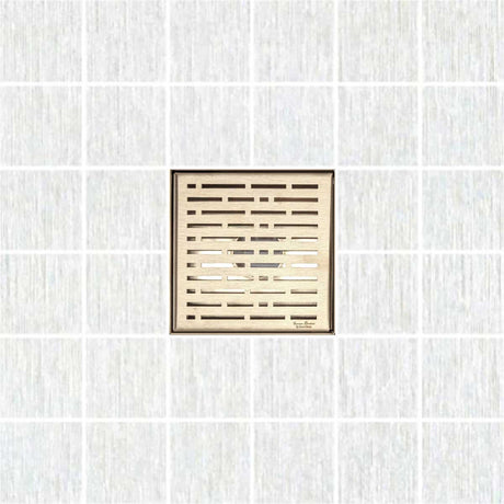 Decorative square shower drain cover with a textured pattern on a white background