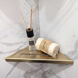 SereneDrains Stainless Steel Satin Gold Corner shower shelf mounted on a marble wall