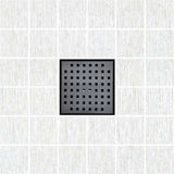 Black square drain cover on a white tiled floor
