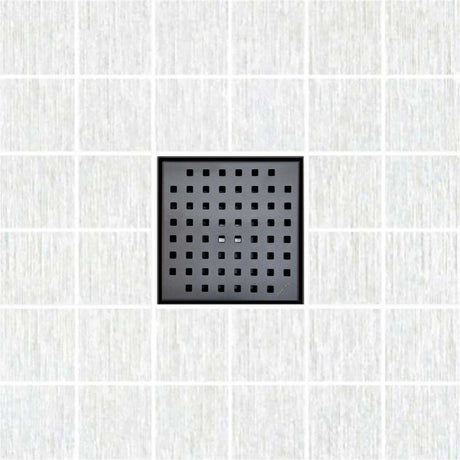 Black square drain cover on a white tiled floor