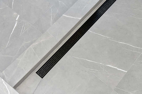 SereneDrains broken Lane Linear shower drain in Matte Black over grey tile