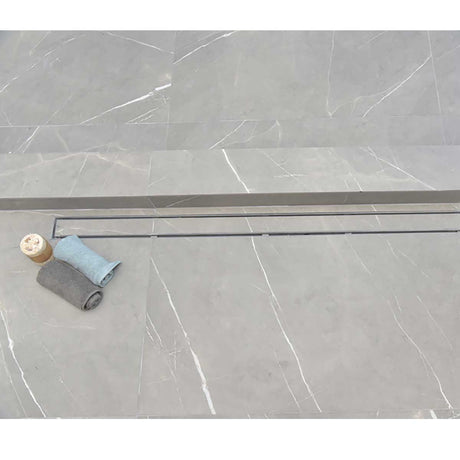 SereneDrains Linear Shower Drain Tile Insert Brushed Nickel over grey porcelain tile 