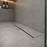 Close-up of concealed linear shower drain with side drainage gap