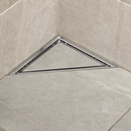 Triangle stainless steel shower floor drain installed in a modern tiled shower
