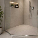 Stainless steel triangle floor drain installed in a contemporary walk-in shower