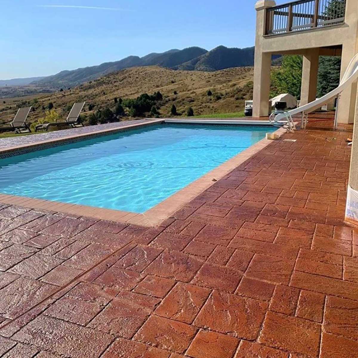 Smith Paint sealer over Pool area with a brick patio and mountain view
