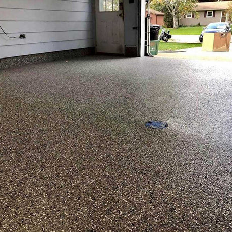 Polished concrete floor in a residential garage with visible speckles using Smith Paint Poly-SB
