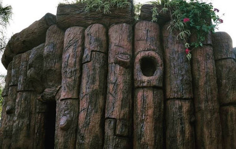 Wooden log structure with natural texture and plants on top applied with Smith Paint Poly-SB