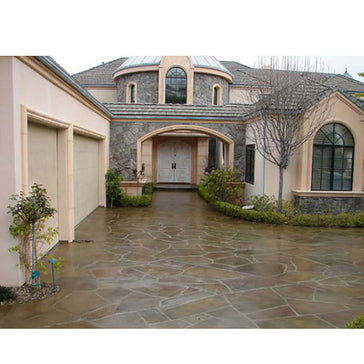 Luxurious house with stone driveway and manicured garden