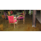Dining area with chairs and a glass table on a polished concrete floor.