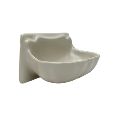 A small ceramic wall-mounted dish with a wavy, organic shape in a glossy off-white finish,