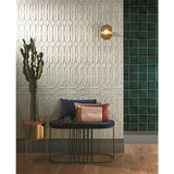 Modern interior with Takao Magnolia 3x6 3D Matte Porcelain Wall Tile, a bench with pillows, and a cactus plant.