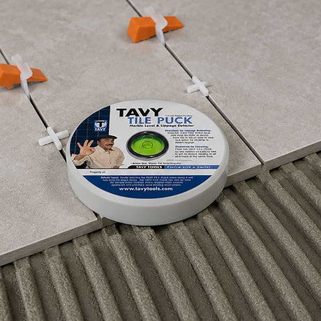 TAVY Tile Puck used with tile spacers to check tile level and alignment during floor tile installation