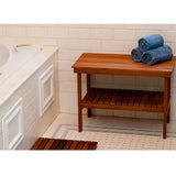 Teak storage bench beside freestanding bathtub