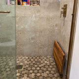 Fold down teak shower seat in luxury bathroom
