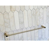 TileWare Towel Bar Promessa Series  Gold towel bar mounted on a tiled wall with geometric pattern