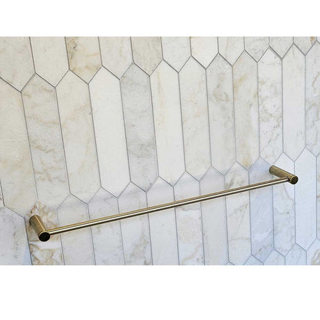 TileWare Towel Bar Promessa Series  Gold towel bar mounted on a tiled wall with geometric pattern