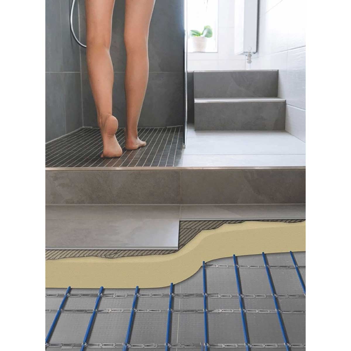 Person standing on a wet floor with a close-up of a Warmup In-slab Heating Cable System