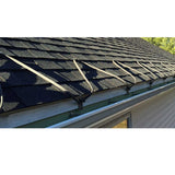 Gutter system on a roof with visible rain gutters and downspouts.